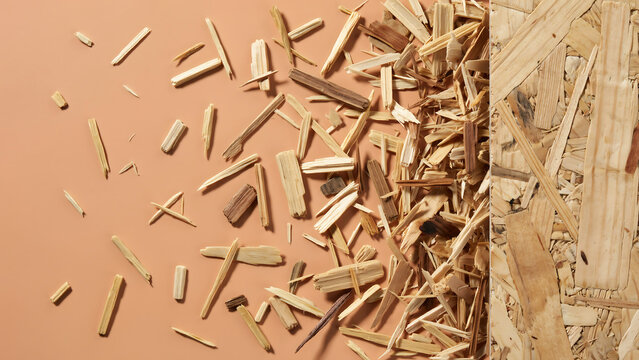 Wood chips and splinters scattered next to a wooden panel with wood chip wood material wood dust wood grain