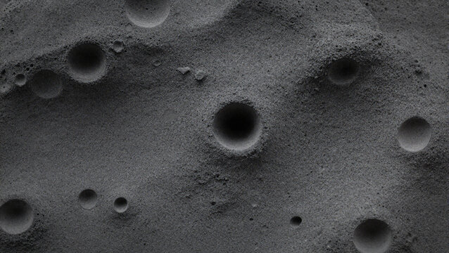 Detailed lunar cratered surface texture in monochrome