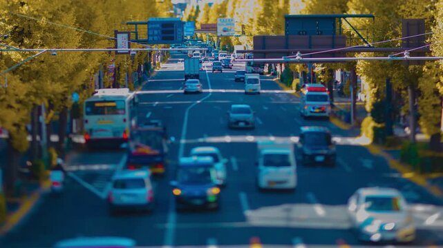 A timelapse of miniature traffic jam at the yellow gingko street in Tokyo zoom