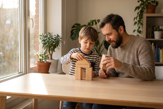Father and son build wooden blocks together for learning and bonding