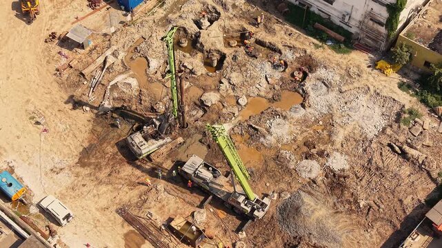 Drilling rig boring foundation on construction land with heavy machinery site development