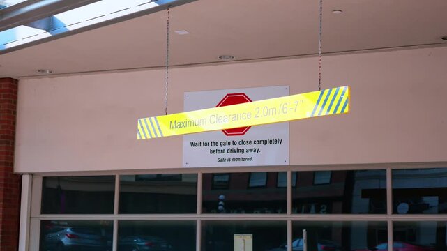 Hanging Maximum Clearance Warning Bar at Parking Garage Entrance