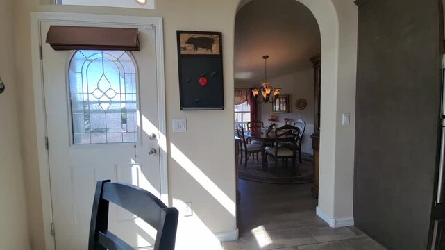 Sunny dining room with round table and flowers