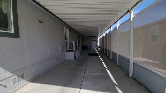 Sunlit suburban house with carport