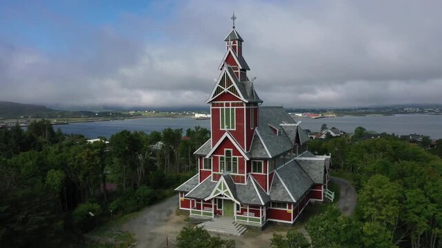 Drone video, red wooden architecture church, Buksnes parish church, Gravdal, Nordland, Norway