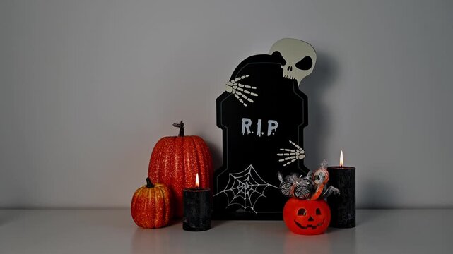 Copy space halloween spooky fall footage with decorations against a wall. Treat or trick sweets and black candles.