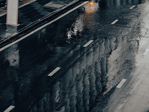 Rain Soaked Road with Lane Markings and Reflections, Wet Street Aerial View