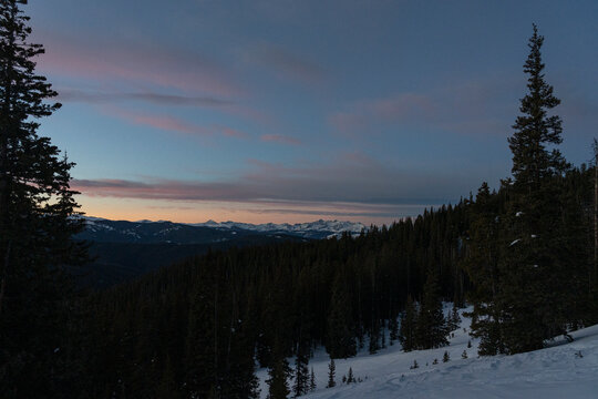 Winter Twilight Over Snowy Mountain Range