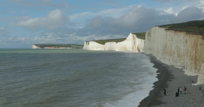 Clouds, waves, sea, beach, people, chalk cliffs Seven Sisters, Birling Gap near Eastbourne, East Sussex, England, Great Britain