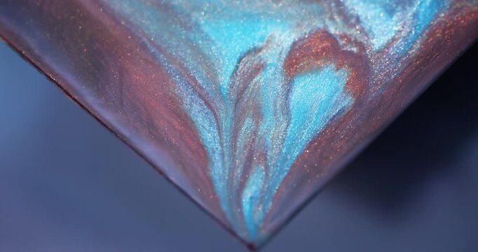 Shimmer paint. Sparkling fluid. Defocused blue orange purple color triangle marble mix texture spilling on abstract art background.