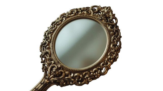 Vintage ornate hand mirror with intricate gold filigree and reflective surface resting on a transparent background.