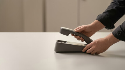 Fototapeta premium Contactless payment payment terminal crisis management concept with human hand using contactless payment terminal for secure transaction