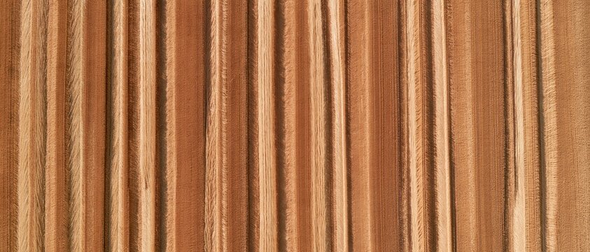 Abstract texture of harvested barley field with vertical straw patterns and warm golden tones