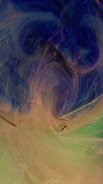Vertical video. Paint smoke flow. Glitter vapor. Defocused blue pink green colorful sparkling wet blend pigment filling broken glass on underwater abstract background.