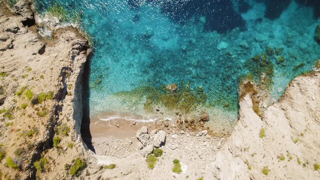 Rocky beach with clear sea waters and stones seen from above on Kefalonia island