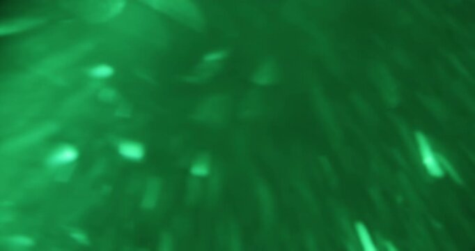 Bokeh green texture. Natural light. Blur vibrant color radiant glimmer optical glint flicker visual bright lens flare on art background.