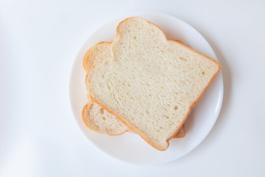 Top view white bread slices in plate isolated on white background. Food background.