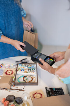 woman using smartphone for contactless payment with EDC payment representing digital finance and cashless technology adoption