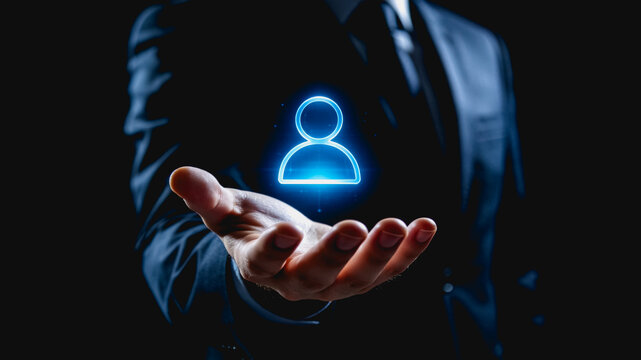 A business professional in a suit holds out a hand displaying a glowing user account hologram symbol, representing customer management or digital identity.