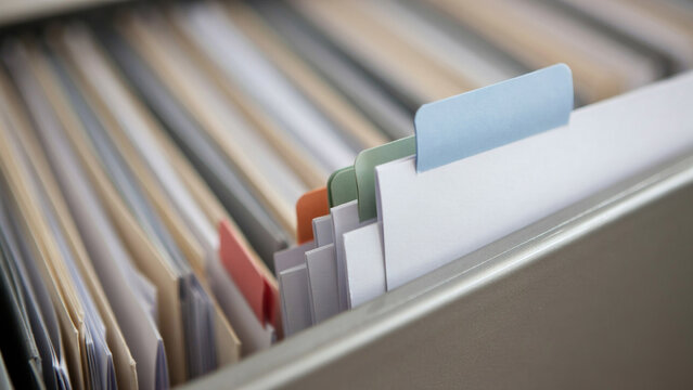 open filing cabinet drawer with organized hanging file folders and documents
