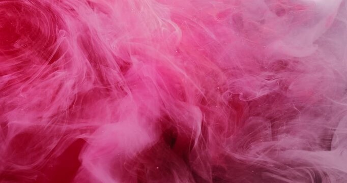 Color mist. Red paint. Defocused pink underwater vapor liquid glitter water bright texture spreading on abstract vibrant art background.