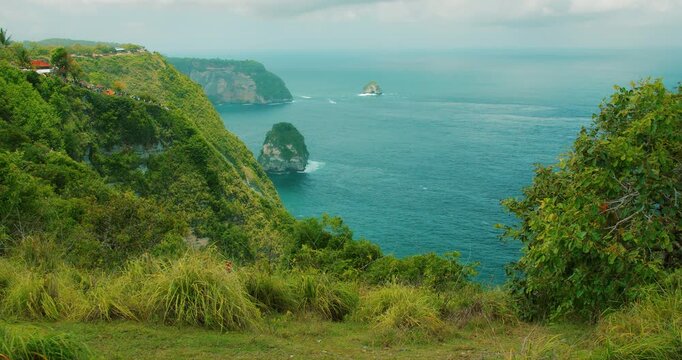 Walking path leads along the high cliffs of Nusa Penida Island in Bali