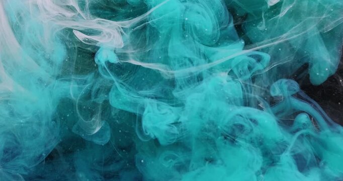 Ink cloud. Underwater fog. Defocused blue white color liquid mix water droplets acrylic fluid spreading on abstract black art background.