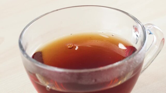 Dipping and Steeping a Tea Bag in a Glass Cup