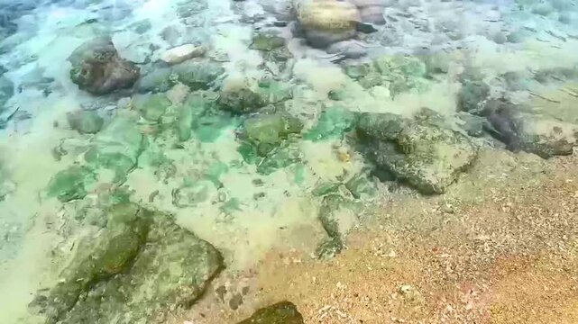 Tropical Merlin Beach Coral Rocks Surrounded By Clear Water And Waves Thailand.
