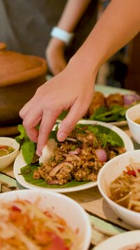 Person Eating Thai Larb Moo Minced Pork Salad with Sticky Rice