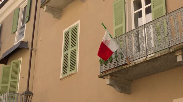Italian Flag Hanging from Balcony of Traditional Apartment Building