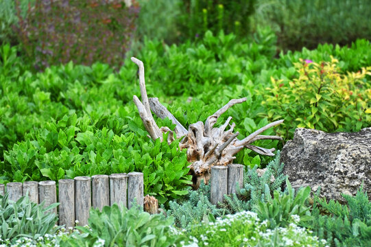 Driftwood like decor of flowerbed
