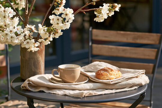 Coffee and pastry on elegant spring cafe terrace