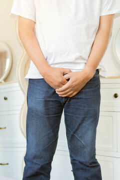 Vertical shot of man covers groin, health problems disease for premature ejaculation