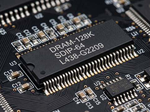 Dynamic random access memory silicon chip soldered on black multichip printed circuit.