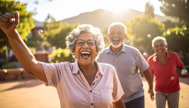 Active senior friends celebrating victory after a bocce ball game outdoors