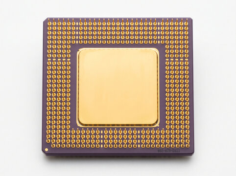 Square computer central processing unit with golden surface and metal pin grid array base.