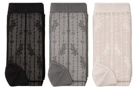 Women's patterned sheer stocking three-pack, nylon mesh, black, grey and ivory, vertical floral motif and reinforced toe. Flat lay isolated on white background for hosiery retail.