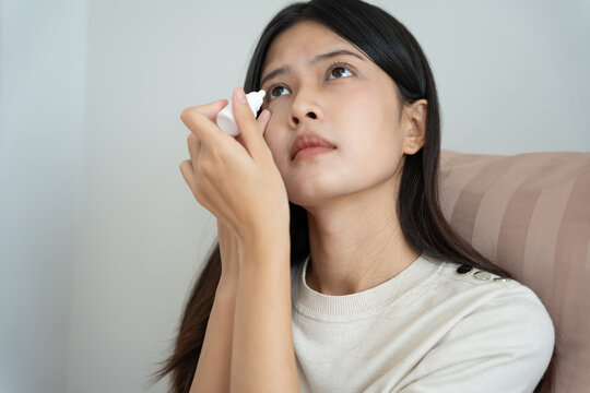 Eye problems, Asian women use artificial Tears, Antibiotic,  eye irritation, eye rubbing, dry, eye pain after work for long time, migraine, headache, blurred vision, photophobia, small words