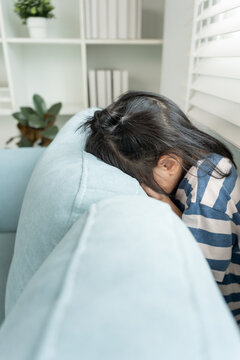 little asian children kid playing hide and seek standing behind the sofa, Adorable child having fun in the home. happy family have fun with kids, activity, learning, activity, game, meditation