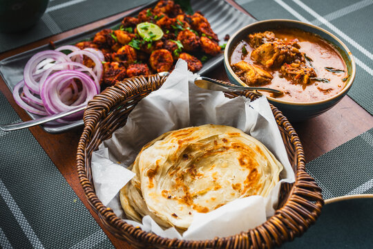 Kerala food with paratha chicken curry and prawn roast
