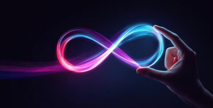 A human hand holding a glowing neon infinity symbol made of vibrant pink and blue light trails against a dark background