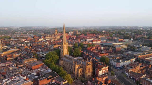 Aerial view of Wakefield, a cathedral city located on the River Calder in West Yorkshire, England, United Kingdom. Drone POV of Wakefield Cathedral  and city centre in early mornings sunrise.