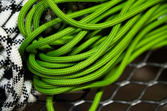 Coiled bright green climbing rope close-up