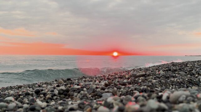 Timelapse Calm waves at sunset. Wave splashing over pebbles at sea with foam. Rolling ocean waves. Summer paradise beach background at sunset timelapse. 