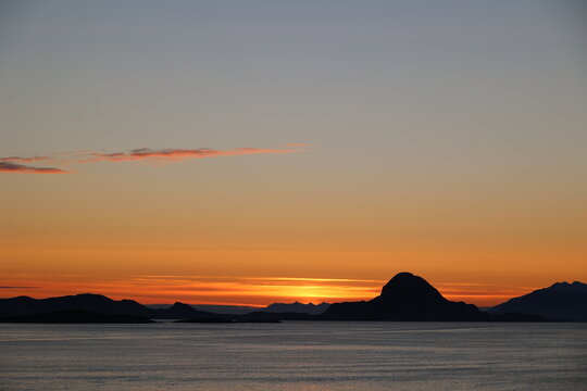 Sunrise on the horizon of the famous Torghatten rock, Norway