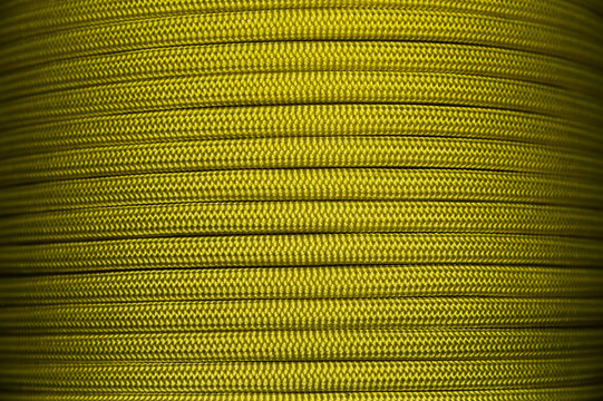 Close-up of yellow nylon paracord tightly spooled