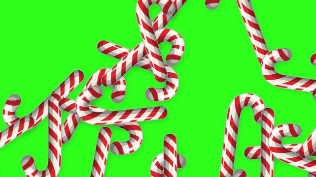 Red and White Striped Candy Canes Falling on Green Screen Background