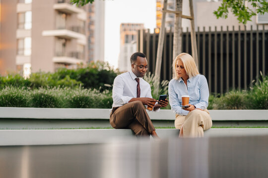 Business colleagues discussing work during urban coffee break