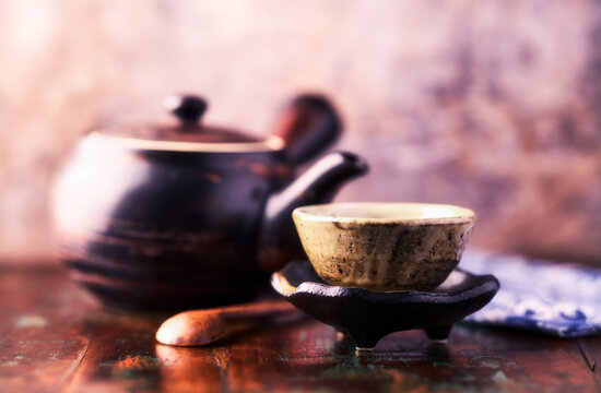 Traditional japanese ceramic on rustic wooden background. Soft focus. Copy space.